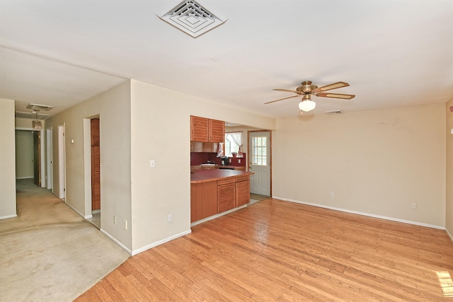 64 S Nassau St, Bethpage, NY 11714 - unfurnished living room with light wood-type flooring, baseboards, and ceiling fan