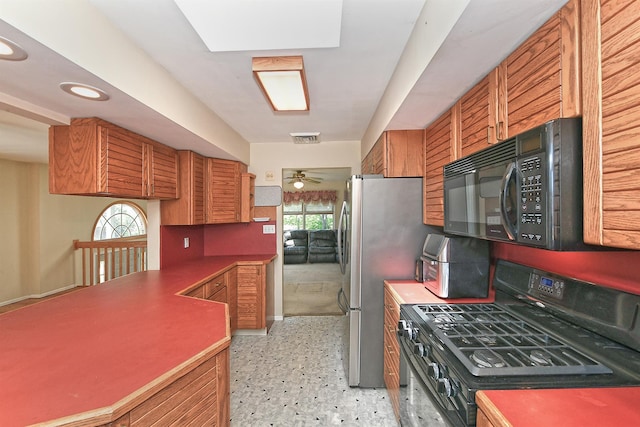 64 S Nassau St, Bethpage, NY 11714 - kitchen featuring black appliances, ceiling fan, brown cabinetry, dark aggregate flooring, and recessed lighting