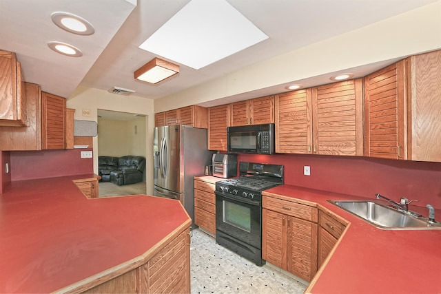 64 S Nassau St, Bethpage, NY 11714 - kitchen with black appliances, a sink, brown cabinetry, and recessed lighting