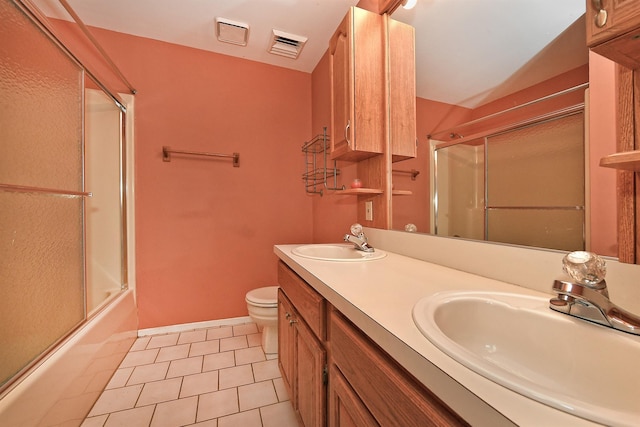 64 S Nassau St, Bethpage, NY 11714 - full bathroom featuring toilet, enclosed tub / shower combo, double vanity, tile patterned floors, and baseboards