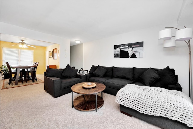 carpeted living room featuring ceiling fan