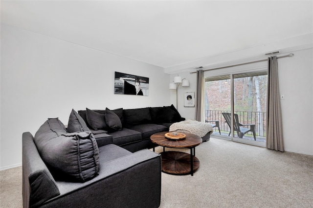 living area featuring carpet floors and baseboards