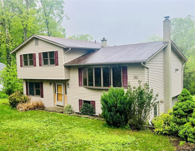 51 Pine Ct, Middletown, NY 10941 - view of front of house with a chimney, a front yard, and roof with shingles