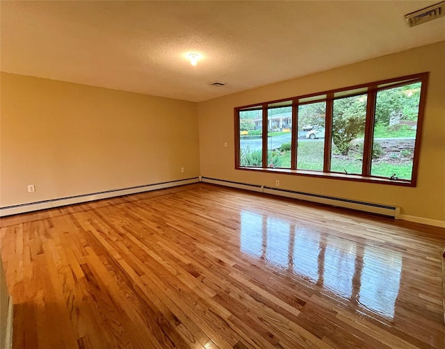 51 Pine Ct, Middletown, NY 10941 - empty room featuring wood finished floors, a baseboard heating unit, and baseboards