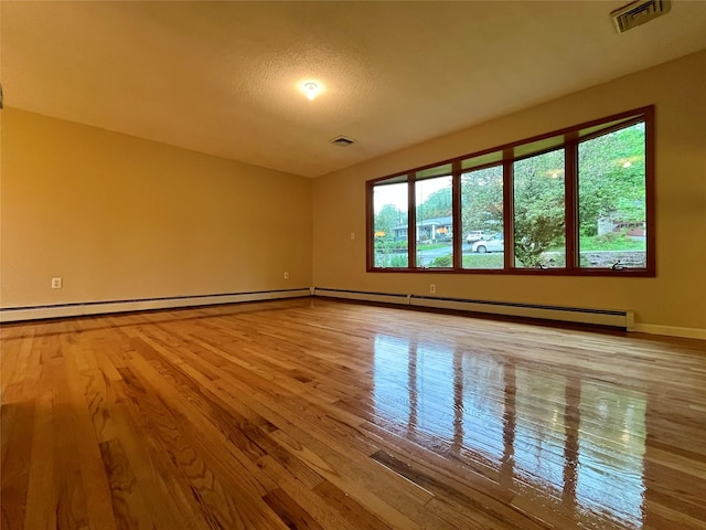 51 Pine Ct, Middletown, NY 10941 - spare room with wood finished floors, baseboards, and a baseboard heating unit
