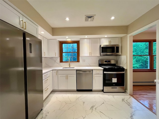 51 Pine Ct, Middletown, NY 10941 - kitchen featuring appliances with stainless steel finishes, a baseboard radiator, a sink, light countertops, and light marble finish floors