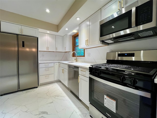 51 Pine Ct, Middletown, NY 10941 - kitchen with appliances with stainless steel finishes, a sink, light marble finish flooring, recessed lighting, and light countertops