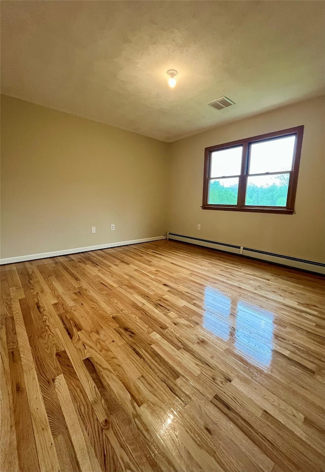 51 Pine Ct, Middletown, NY 10941 - empty room with baseboard heating, light wood-style flooring, and baseboards