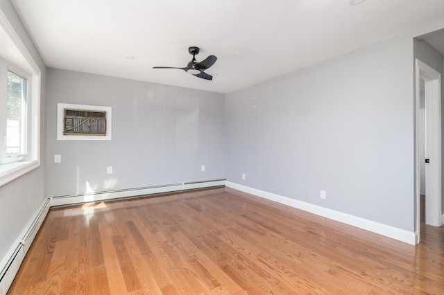 13 Curve Ln, Levittown, NY 11756 - empty room featuring a baseboard radiator, ceiling fan, and wood finished floors