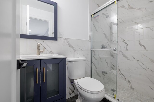13 Curve Ln, Levittown, NY 11756 - full bathroom featuring a marble finish shower, tile walls, toilet, and vanity