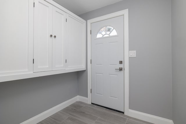 13 Curve Ln, Levittown, NY 11756 - foyer with baseboards and wood finish floors