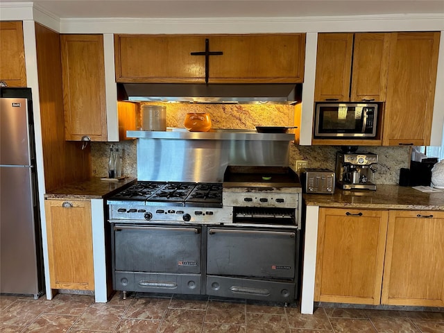 139 Coronado St, Atlantic Beach, NY 11509 - kitchen featuring stainless steel appliances, decorative backsplash, brown cabinetry, and ventilation hood