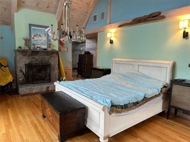 139 Coronado St, Atlantic Beach, NY 11509 - bedroom featuring wooden ceiling, wood finished floors, lofted ceiling, a stone fireplace, and a chandelier