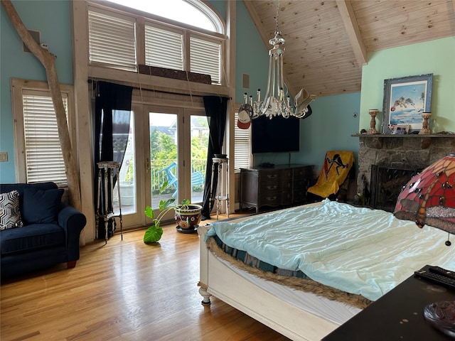 139 Coronado St, Atlantic Beach, NY 11509 - bedroom featuring multiple windows, access to exterior, wood finished floors, a fireplace, and high vaulted ceiling