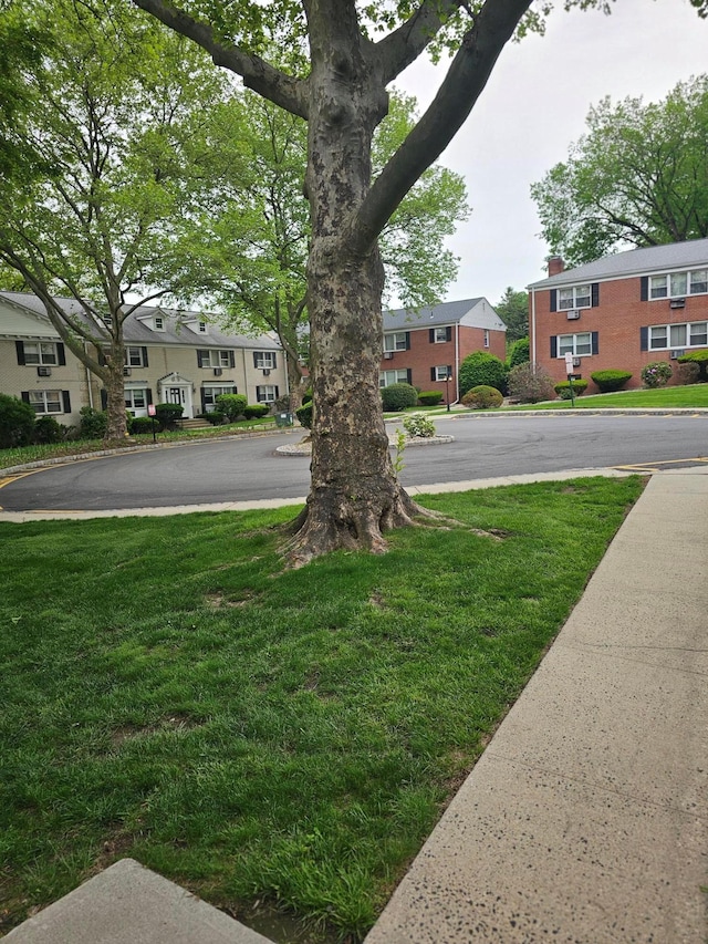 view of green lawn with a residential view