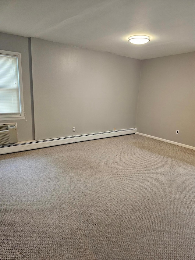 carpeted spare room featuring baseboard heating, a wall mounted air conditioner, and baseboards
