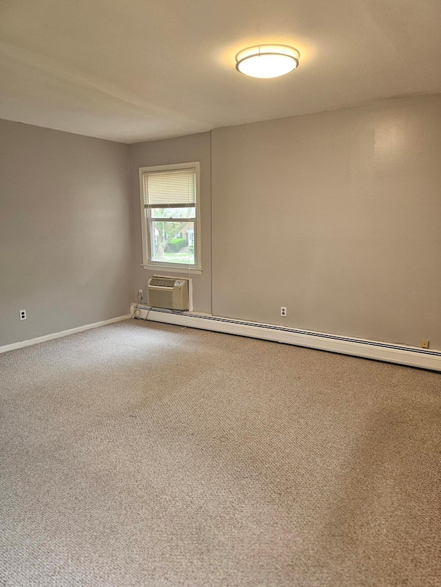 carpeted spare room with a wall unit AC, baseboards, and a baseboard heating unit