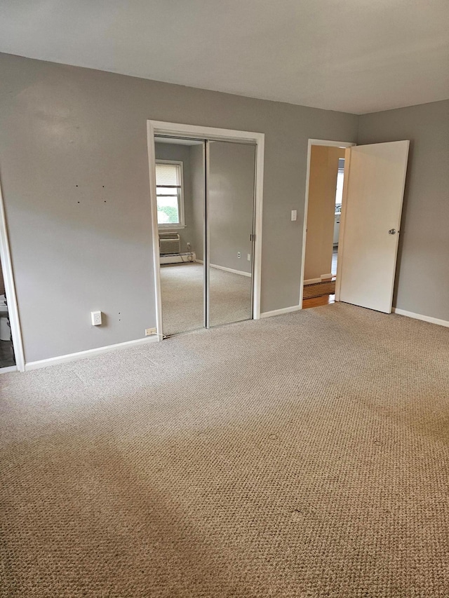 unfurnished bedroom with carpet floors, baseboards, and a closet