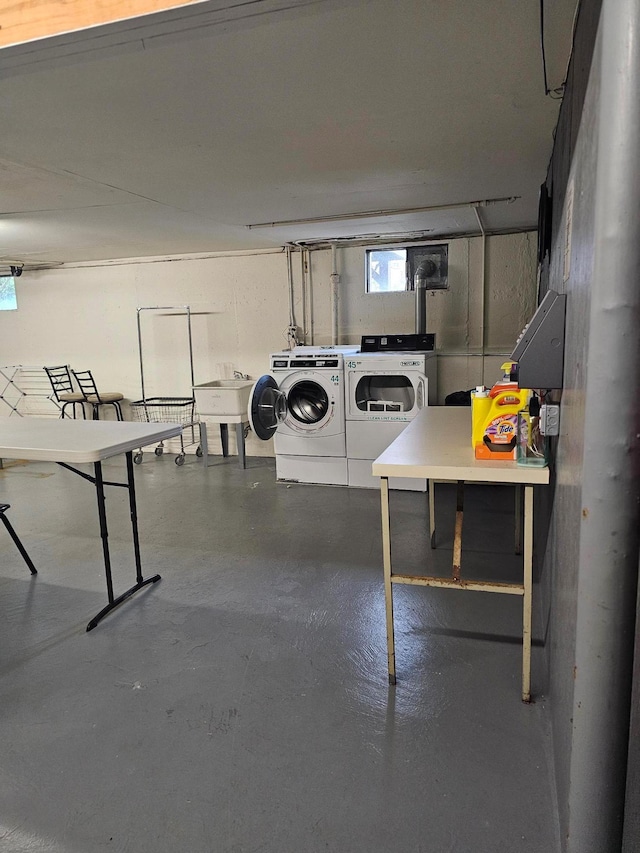 basement featuring washing machine and dryer and a sink