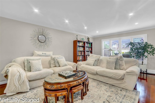 living area with hardwood / wood-style flooring, recessed lighting, ornamental molding, and baseboards