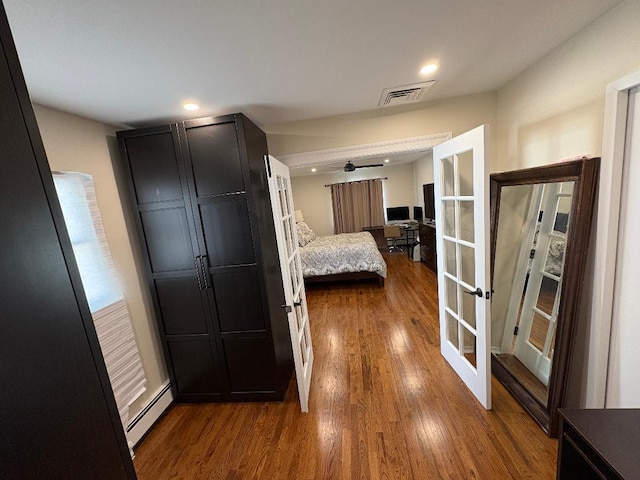 bedroom featuring a baseboard radiator, french doors, dark wood-style floors, and recessed lighting