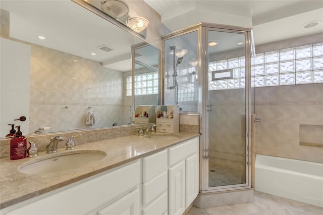 full bathroom with tile patterned flooring, a stall shower, double vanity, and a bath