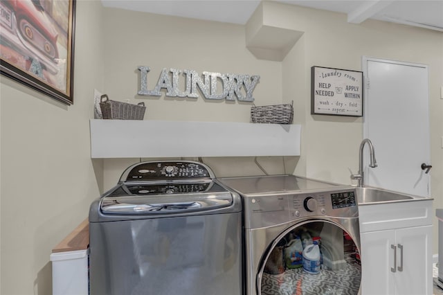 laundry room with independent washer and dryer and cabinet space