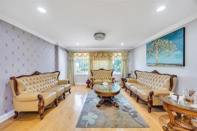 living area featuring wallpapered walls, light wood-style floors, baseboards, ornamental molding, and recessed lighting
