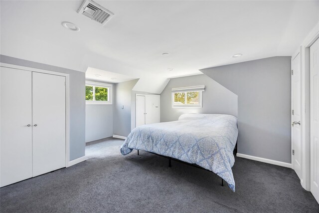 bedroom featuring carpet floors, baseboards, and lofted ceiling
