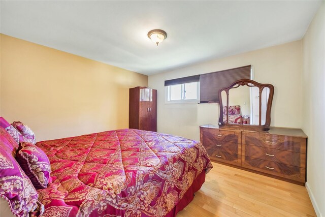 bedroom with hardwood / wood-style flooring
