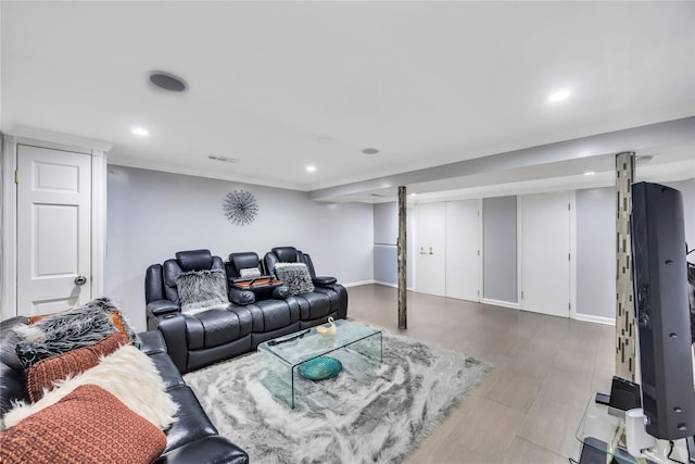 living area with recessed lighting, baseboards, and crown molding