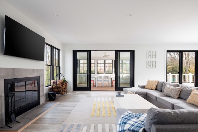 1350 Hortons Ln, Southold, NY 11971 - living area featuring healthy amount of natural light, light wood-type flooring, a fireplace, and ceiling fan