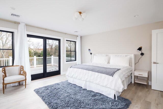 1350 Hortons Ln, Southold, NY 11971 - bedroom featuring access to exterior and light wood-style flooring