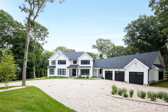 1350 Hortons Ln, Southold, NY 11971 - modern farmhouse featuring board and batten siding, gravel driveway, an attached garage, a standing seam roof, and roof with shingles