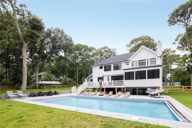 1350 Hortons Ln, Southold, NY 11971 - back of house with a balcony, a patio, an outdoor pool, and board and batten siding