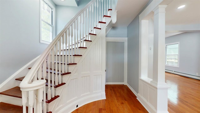 74 Gladstone Ave, Walden, NY 12586 - stairs with wood finished floors, plenty of natural light, ornate columns, baseboards, and recessed lighting