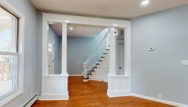 74 Gladstone Ave, Walden, NY 12586 - foyer with baseboard heating, wood finished floors, ornate columns, stairs, and recessed lighting