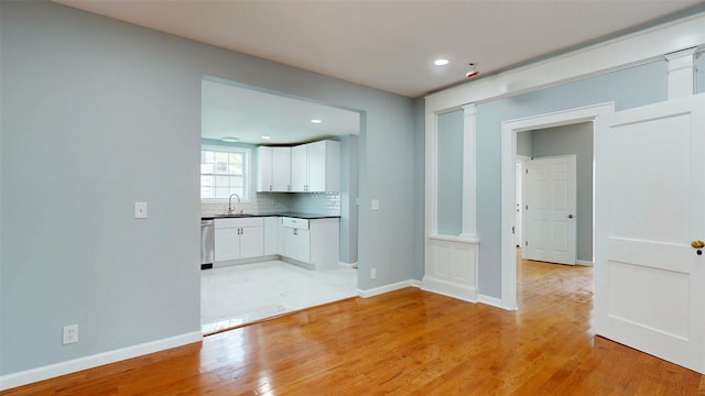 74 Gladstone Ave, Walden, NY 12586 - empty room featuring a sink, light wood-style flooring, baseboards, and recessed lighting