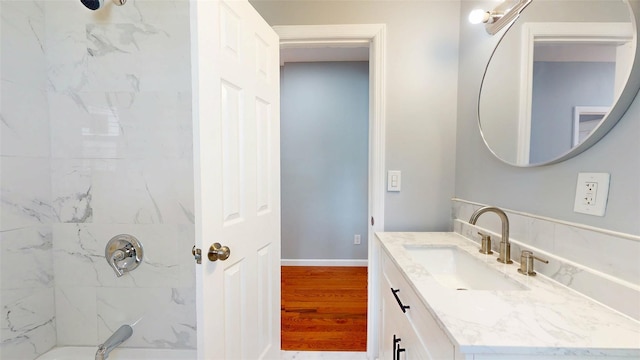 74 Gladstone Ave, Walden, NY 12586 - bathroom featuring a shower, vanity, wood finished floors, and baseboards