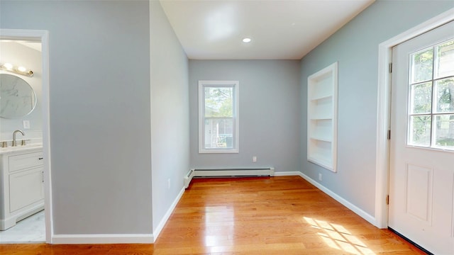 74 Gladstone Ave, Walden, NY 12586 - entryway featuring a baseboard radiator, a sink, light wood finished floors, baseboards, and built in features