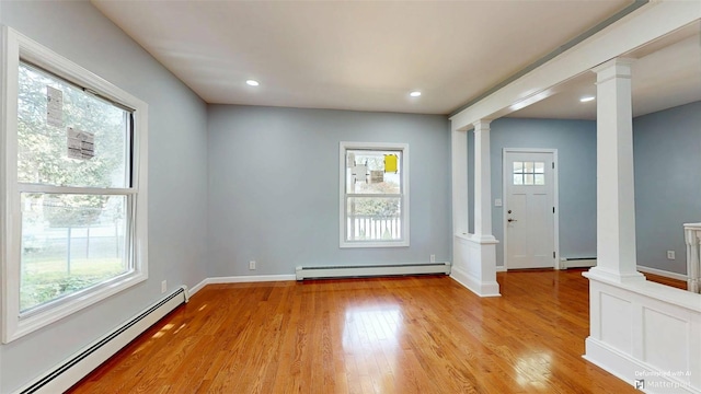 74 Gladstone Ave, Walden, NY 12586 - empty room with ornate columns, a baseboard radiator, baseboard heating, light wood-style flooring, and recessed lighting