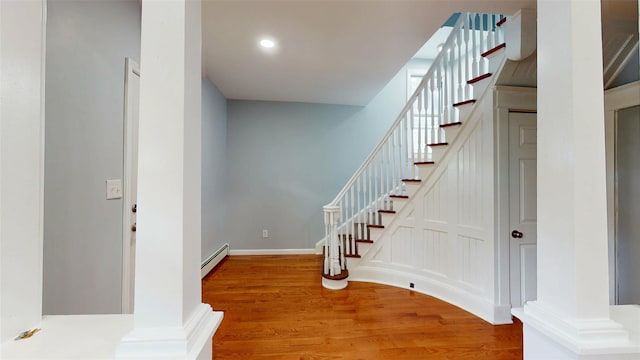 74 Gladstone Ave, Walden, NY 12586 - entrance foyer featuring baseboard heating, wood finished floors, stairs, recessed lighting, and baseboards
