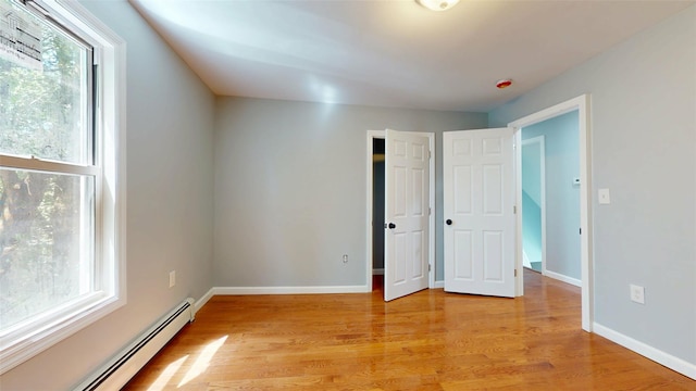 74 Gladstone Ave, Walden, NY 12586 - unfurnished bedroom featuring baseboard heating, light wood-style flooring, and baseboards