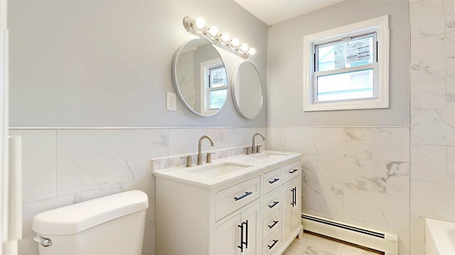 74 Gladstone Ave, Walden, NY 12586 - bathroom featuring a baseboard heating unit, tile walls, toilet, marble finish floors, and double vanity