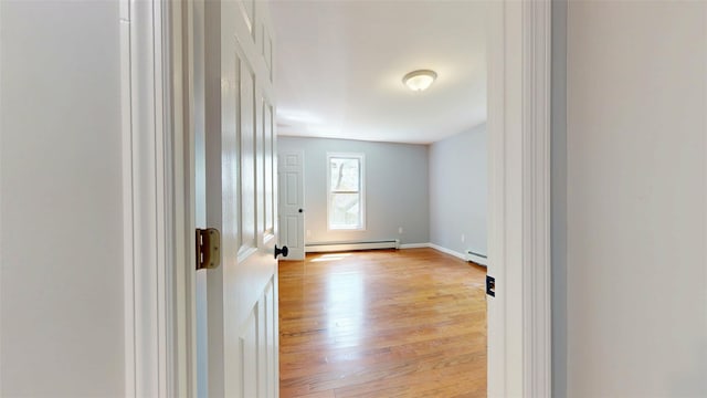 74 Gladstone Ave, Walden, NY 12586 - spare room featuring a baseboard radiator, light wood-type flooring, and baseboards