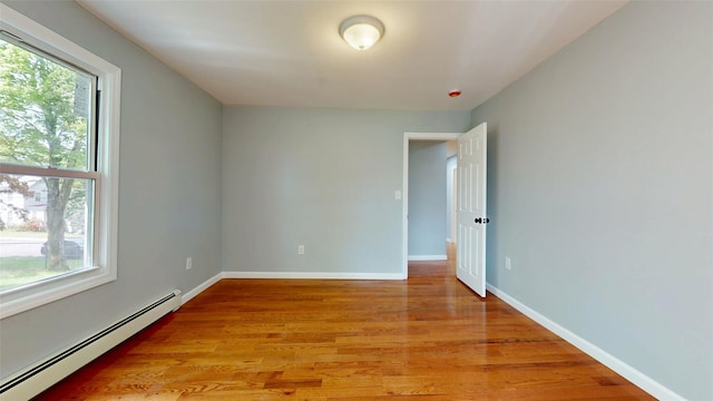 74 Gladstone Ave, Walden, NY 12586 - spare room featuring baseboard heating, light wood-style floors, and baseboards