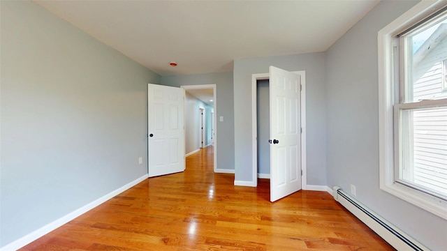 74 Gladstone Ave, Walden, NY 12586 - unfurnished bedroom featuring baseboard heating, light wood-style flooring, and baseboards
