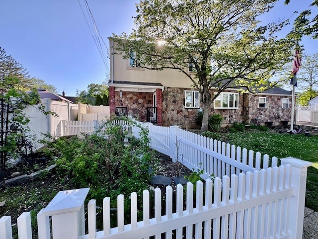980 Siems Ct, North Bellmore, NY 11710 - view of front of house featuring a fenced front yard and stone siding