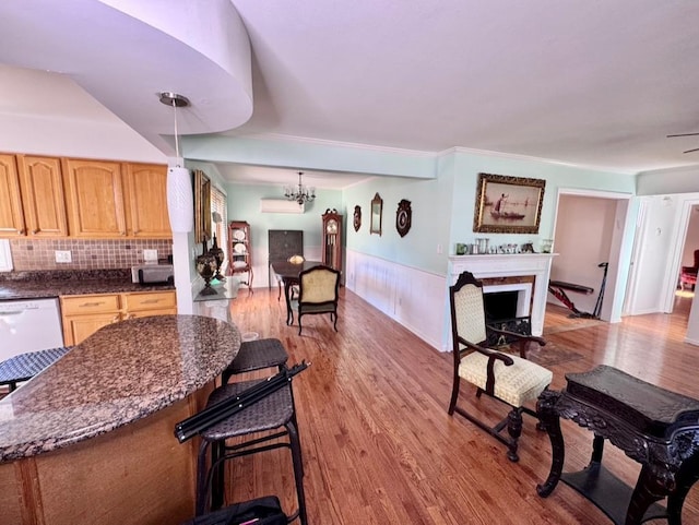980 Siems Ct, North Bellmore, NY 11710 - living room featuring light wood-type flooring, a fireplace, and a chandelier