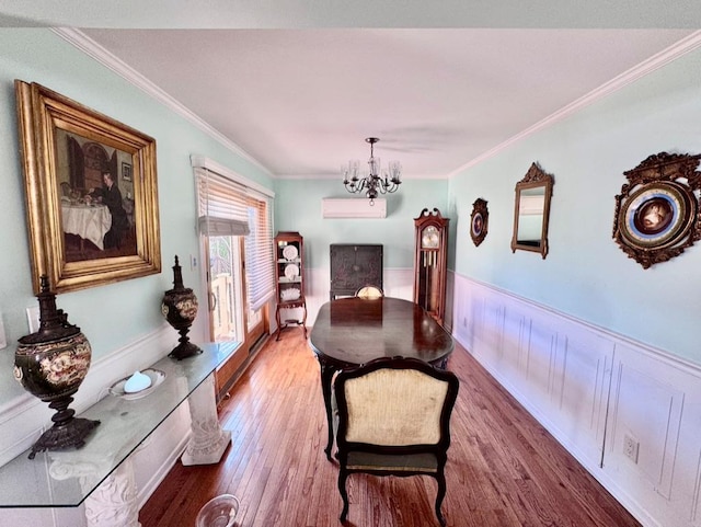 980 Siems Ct, North Bellmore, NY 11710 - dining area featuring a chandelier, crown molding, a wainscoted wall, wood finished floors, and a wall unit AC